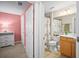 Shot of a bathroom showcasing a separated area featuring a toilet, shower with curtain, and sink area at 5866 Guarino Dr, Sarasota, FL 34238