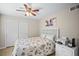 Cozy bedroom featuring neutral walls, a closet, a ceiling fan, and a bed with an ocean-themed comforter at 5866 Guarino Dr, Sarasota, FL 34238