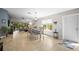 Bright dining area featuring a table for six, window views, and seamless access to the living room and entry way at 5866 Guarino Dr, Sarasota, FL 34238