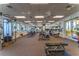 Well-equipped gym with modern machines, ceiling fans, mirrored walls, and plenty of natural light at 5866 Guarino Dr, Sarasota, FL 34238
