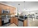 Bright kitchen features stainless steel appliances, granite countertops, and views to the dining and living areas at 5866 Guarino Dr, Sarasota, FL 34238