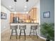 Well-equipped kitchen featuring stainless steel appliances, light wood cabinetry, and a breakfast bar with seating for three at 5866 Guarino Dr, Sarasota, FL 34238