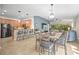 Open-concept living and dining area featuring a modern chandelier, breakfast bar, and sliding doors to the lanai at 5866 Guarino Dr, Sarasota, FL 34238