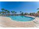 A spacious community pool with lounge chairs and a clear blue sky at 5866 Guarino Dr, Sarasota, FL 34238