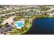 Aerial view of the pool area and amenities near a lake at 5866 Guarino Dr, Sarasota, FL 34238