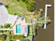 Aerial view of a home's backyard with a pool, dock, and access to the water at 6113 55Th E Ter, Bradenton, FL 34203