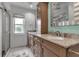 Bathroom with granite countertops, wood cabinets and drawers, and a large mirror at 6113 55Th E Ter, Bradenton, FL 34203