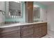 Bathroom with a double sink vanity, granite countertops, and framed mirrors at 6113 55Th E Ter, Bradenton, FL 34203