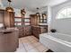Bathroom featuring a soaking tub, stylish fixtures, and ample counter space at 6113 55Th E Ter, Bradenton, FL 34203