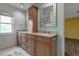 Bathroom with a double sink vanity, granite countertops, and a large mirror at 6113 55Th E Ter, Bradenton, FL 34203