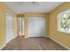 Bedroom with wood-look floors, a closet, and a window at 6113 55Th E Ter, Bradenton, FL 34203
