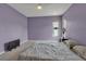 Bedroom featuring a ceiling fan, two large windows, and a cozy, patterned bed at 6113 55Th E Ter, Bradenton, FL 34203