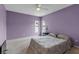 Bedroom with a ceiling fan, two large windows, and a cozy, patterned bed at 6113 55Th E Ter, Bradenton, FL 34203