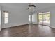 Bright bedroom featuring wood floors, neutral walls, and sliding door access to outdoor pool at 6113 55Th E Ter, Bradenton, FL 34203