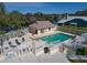 Aerial view of the River Landings community pool surrounded by a white fence and lounge chairs at 6113 55Th E Ter, Bradenton, FL 34203