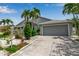 Well-kept home with a neatly paved driveway, mature landscaping, and a neutral-colored exterior at 6113 55Th E Ter, Bradenton, FL 34203