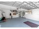 Spacious garage with blue painted floor and tools hanging on the wall at 6113 55Th E Ter, Bradenton, FL 34203