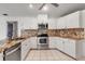 Modern kitchen with stainless steel appliances and a beautiful tile backsplash at 6113 55Th E Ter, Bradenton, FL 34203