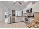 Bright, open kitchen with stainless appliances, granite countertops, and ample lighting at 6113 55Th E Ter, Bradenton, FL 34203