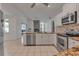 Modern kitchen featuring stainless appliances, granite countertops, and a view to living room at 6113 55Th E Ter, Bradenton, FL 34203