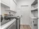 Laundry room with a washing machine and dryer, shelving, and a door to the outside at 6113 55Th E Ter, Bradenton, FL 34203