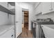 Laundry room with a washing machine, dryer, shelving, and wood grain floors at 6113 55Th E Ter, Bradenton, FL 34203