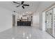 Open-concept layout connecting the kitchen, living room, and outdoor patio with tile flooring at 6113 55Th E Ter, Bradenton, FL 34203