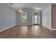 Spacious living room with vaulted ceiling, wood-look floors, large windows, and contemporary light fixtures at 6113 55Th E Ter, Bradenton, FL 34203