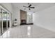 Spacious living room featuring a stone fireplace, sliding glass doors, and tile flooring at 6113 55Th E Ter, Bradenton, FL 34203