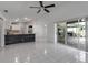 Open-concept layout connecting the kitchen, living room, and outdoor patio with tile flooring at 6113 55Th E Ter, Bradenton, FL 34203