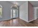 Open-concept living room boasts elegant glass front door, wood floors, and ample natural light at 6113 55Th E Ter, Bradenton, FL 34203