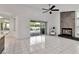 Spacious living room featuring a stone fireplace, sliding glass doors, and access to pool area at 6113 55Th E Ter, Bradenton, FL 34203