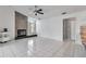 Spacious living room featuring a stone fireplace, tile flooring, and ample natural light at 6113 55Th E Ter, Bradenton, FL 34203