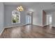 Inviting living room with hardwood floors, arched windows, high ceilings, and designer lighting at 6113 55Th E Ter, Bradenton, FL 34203