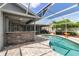 Refreshing pool with screened-in lanai, outdoor bar, and brick pavers creating a resort-like atmosphere at 6113 55Th E Ter, Bradenton, FL 34203