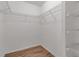 Walk-in closet with wood-look floors and shelving at 6113 55Th E Ter, Bradenton, FL 34203