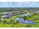 Aerial view of a lakeside community with lush greenery and easy access to the highway at 6125 Anise Dr, Sarasota, FL 34238