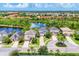 A tranquil community featuring well-manicured lawns, serene lakes, and lush greenery in an aerial view at 6125 Anise Dr, Sarasota, FL 34238