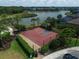 This outdoor basketball court with mature landscaping features a gated entrance and an adjacent lake at 6125 Anise Dr, Sarasota, FL 34238