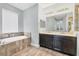 Bathroom featuring large soaking tub and double sink vanity at 6125 Anise Dr, Sarasota, FL 34238