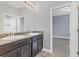 Bathroom with double vanity sinks and granite countertop, neutral paint, and tile flooring at 6125 Anise Dr, Sarasota, FL 34238