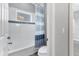 Bright bathroom features tub with shower and stylish blue-striped curtain at 6125 Anise Dr, Sarasota, FL 34238