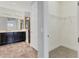 Bathroom featuring double sink vanity and walk-in closet at 6125 Anise Dr, Sarasota, FL 34238