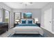 Well-lit bedroom with gray walls, a plush bed, and tasteful decor at 6125 Anise Dr, Sarasota, FL 34238