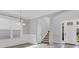 Bright foyer showcasing tile flooring, elegant archways, and a staircase leading to the upper level at 6125 Anise Dr, Sarasota, FL 34238
