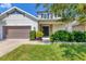 Charming home with a manicured lawn, a two-car garage, and a welcoming front porch at 6125 Anise Dr, Sarasota, FL 34238