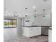 Open-concept kitchen and living area with an island and view of a screened-in pool at 6125 Anise Dr, Sarasota, FL 34238