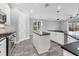Modern kitchen featuring white cabinets, stainless steel appliances, and a center island at 6125 Anise Dr, Sarasota, FL 34238
