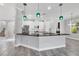 Stylish kitchen with white cabinets, stainless steel appliances, and a spacious island with seating at 6125 Anise Dr, Sarasota, FL 34238