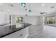 Open kitchen flowing into a spacious living area with access to the outdoor patio and pool at 6125 Anise Dr, Sarasota, FL 34238